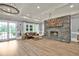 Spacious lounge area boasts a stone fireplace, modern light fixture, and access to the outdoors at 207 Harmony Lake Dr, Canton, GA 30115