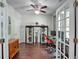 Comfortable home office featuring hardwood floors, a ceiling fan, and decorative shelving at 207 Harmony Lake Dr, Canton, GA 30115