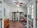 Bright home office with wood floors, a ceiling fan, and glass doors to a rear deck at 207 Harmony Lake Dr, Canton, GA 30115