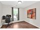 Office space featuring hardwood floors, a desk, and a window with natural light at 207 Harmony Lake Dr, Canton, GA 30115