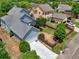 Aerial view showcasing home's well-kept lawn, fenced yard, driveway, and mature tree lined grounds at 207 Harmony Lake Dr, Canton, GA 30115