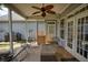 Inviting screened porch with comfortable seating and a ceiling fan for relaxing outdoors at 207 Harmony Lake Dr, Canton, GA 30115