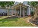 Charming screened porch with ceiling fan, wood accents, stone pathway, and adjacent grill area at 207 Harmony Lake Dr, Canton, GA 30115