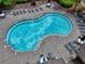 A serene view of the community pool with ample seating for residents to enjoy under the sun at 207 Harmony Lake Dr, Canton, GA 30115