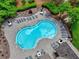 Enjoy a relaxing time at the community pool, featuring plenty of lounge chairs and tables with umbrellas at 207 Harmony Lake Dr, Canton, GA 30115