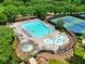Aerial view of a stylish pool area with seating, an umbrella, and easy access to the tennis court at 207 Harmony Lake Dr, Canton, GA 30115