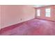 Spacious bedroom featuring pink walls and carpet, plus two windows for natural light at 350 Pleasant Oak Sw Ct, Marietta, GA 30008