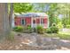 Charming single-story home with a red exterior, inviting front porch, and lovely landscaped front yard at 350 Pleasant Oak Sw Ct, Marietta, GA 30008