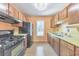 Functional kitchen with wood cabinets, black appliances, and ample counter space, ready for culinary adventures at 350 Pleasant Oak Sw Ct, Marietta, GA 30008