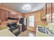 Well-lit kitchen featuring wood cabinetry, a functional layout, and updated black appliances at 350 Pleasant Oak Sw Ct, Marietta, GA 30008
