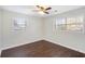 The bedroom offers two windows for natural light and hardwood floors at 1602 Sycamore Nw Dr, Kennesaw, GA 30152