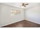 This bedroom features sleek hardwood floors, a ceiling fan, and a light-filled window at 1602 Sycamore Nw Dr, Kennesaw, GA 30152