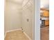This laundry room has shelving with view into the kitchen with stainless steel appliances at 1602 Sycamore Nw Dr, Kennesaw, GA 30152