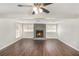 Living room featuring wood floors, stone fireplace, and large windows at 1602 Sycamore Nw Dr, Kennesaw, GA 30152