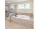 Modern bathroom with a separate glass shower and soaking tub, tiled with gray stone at 2462 Adair Ridge Ct, Decatur, GA 30034