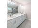 Bathroom features a double sink vanity, large mirror, and a glass door shower with gray stone tile at 2462 Adair Ridge Ct, Decatur, GA 30034