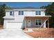 Two-story home with gray siding, white trim, an attached garage, and a covered front porch at 2462 Adair Ridge Ct, Decatur, GA 30034