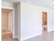 Hallway with two open doorways, neutral walls, and hardwood floors at 2462 Adair Ridge Ct, Decatur, GA 30034
