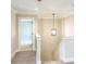 Open hallway with elegant lighting, staircase, and neutral color palette at 2462 Adair Ridge Ct, Decatur, GA 30034