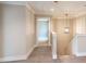 Hallway with neutral color palette, staircase and an open doorway at 2462 Adair Ridge Ct, Decatur, GA 30034