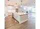 Open-concept kitchen features stainless dishwasher, stone countertops, and center island with seating, leading to living room at 2462 Adair Ridge Ct, Decatur, GA 30034
