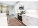 Modern kitchen with white cabinets, stainless steel range, and stone countertops with subway tile backsplash at 2462 Adair Ridge Ct, Decatur, GA 30034