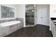 A bathroom features a soaking tub with tile surround and walk-in shower at 3394 Bryerstone Se Cir, Smyrna, GA 30080