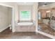 A luxury bathroom features a soaking tub and walk-in shower with pebble floor at 3394 Bryerstone Se Cir, Smyrna, GA 30080