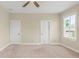 A bright bedroom with neutral walls, two doors, one window, and a ceiling fan at 3394 Bryerstone Se Cir, Smyrna, GA 30080