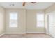 A carpeted bedroom featuring two bright windows and a white door at 3394 Bryerstone Se Cir, Smyrna, GA 30080