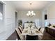 Elegant dining room with wainscoting, modern chandelier, and stylish furnishings at 3394 Bryerstone Se Cir, Smyrna, GA 30080