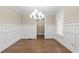 Bright dining room with beautiful trim work, hardwood floors, and a modern chandelier at 3394 Bryerstone Se Cir, Smyrna, GA 30080
