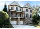 Charming two-story brick home with a stone foundation, a covered porch, and a two-car garage at 3394 Bryerstone Se Cir, Smyrna, GA 30080