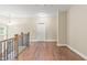 Hallway with wood floors, wooden stair railings and natural lighting at 3394 Bryerstone Se Cir, Smyrna, GA 30080