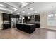 Spacious kitchen with stainless steel appliances, a center island, and sleek dark cabinetry at 3394 Bryerstone Se Cir, Smyrna, GA 30080