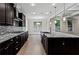 Kitchen showcasing dark cabinetry, granite countertops, and stainless steel appliances at 3394 Bryerstone Se Cir, Smyrna, GA 30080