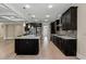 Open kitchen featuring an island with granite countertops, dark cabinetry, and stainless appliances at 3394 Bryerstone Se Cir, Smyrna, GA 30080