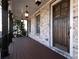 Inviting covered porch with a brick facade, hanging lights, and dark wood flooring at 3394 Bryerstone Se Cir, Smyrna, GA 30080