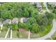 Aerial view of the property surrounded by mature trees in a residential neighborhood at 4355 Old Hamilton Mill Rd, Buford, GA 30518