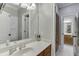 Bathroom featuring a well-lit vanity with wood cabinets and a view of the bedroom at 4355 Old Hamilton Mill Rd, Buford, GA 30518