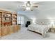 Bright, carpeted bedroom with a ceiling fan, built in cabinet and storage and ample lighting at 4355 Old Hamilton Mill Rd, Buford, GA 30518