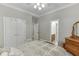 Bright bedroom with a view to the en-suite bath, showcasing ample storage and a comfortable space at 4355 Old Hamilton Mill Rd, Buford, GA 30518