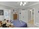 Spacious bedroom showcasing neutral walls, plush bedding, and ample storage, with views to the hallway and bath at 4355 Old Hamilton Mill Rd, Buford, GA 30518