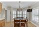 Dining area with large windows providing ample natural light and hardwood floors with direct kitchen access at 4355 Old Hamilton Mill Rd, Buford, GA 30518