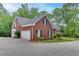 Beautiful brick home with a two-car garage, lush landscaping, and well-maintained grounds at 4355 Old Hamilton Mill Rd, Buford, GA 30518