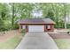Exterior of the garage featuring a single-car door and driveway at 4355 Old Hamilton Mill Rd, Buford, GA 30518