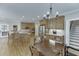 Kitchen with an island, stainless steel appliances, hardwood floors and adjacent breakfast table area and stairs at 4355 Old Hamilton Mill Rd, Buford, GA 30518