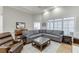 Comfortable living room with a plush sectional sofa, hardwood floors, and ample natural light at 4355 Old Hamilton Mill Rd, Buford, GA 30518