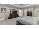 A luxurious main bedroom with neutral carpet, tray ceiling and en suite bath at 4355 Old Hamilton Mill Rd, Buford, GA 30518