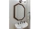 Powder room featuring a pedestal sink and decorative mirror with bronze hardware at 4355 Old Hamilton Mill Rd, Buford, GA 30518